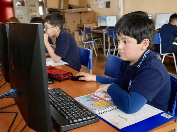 Estudiantes trabajando con computadores en la sala de computación
